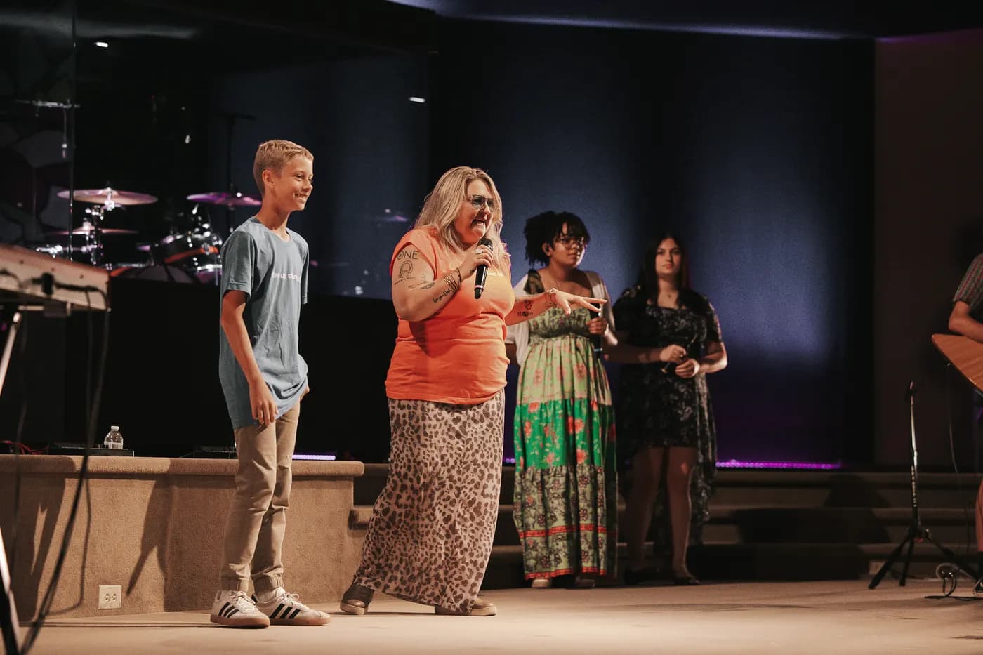 The youth pastor and a student on stage together